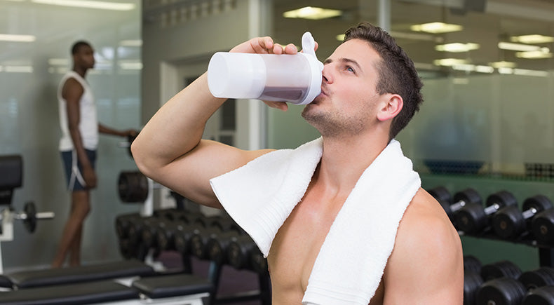 Bodybuilder drinking protein drink